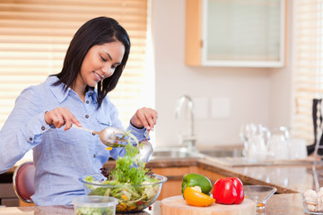 Obraz na płótnie Canvas Woman stirring salad