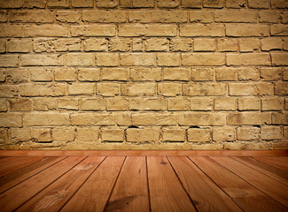 vintage brown grungy textured brick interior with wooden floor