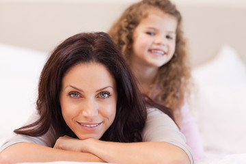 Mother and daughter relaxing on the bed