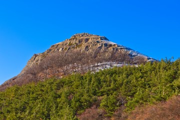 conical mountain on a blue sky background