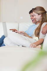 Portrait of a couple using a laptop