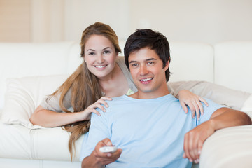 Obraz na płótnie Canvas Happy couple watching television