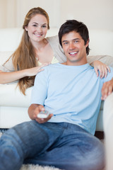 Portrait of a couple watching television