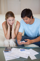 Portrait of a couple looking at their bills