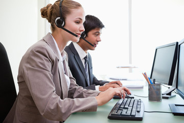 Sales assistants working with computers