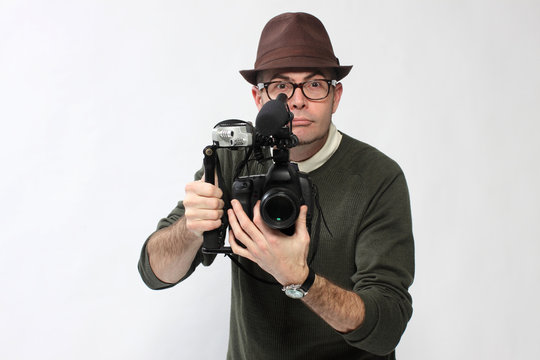 Man with HD SLR camera and audio equipment