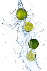 Fresh limes with water splash, isolated on white background