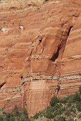 A Team of Climbers Ascend a Sandstone Cliff