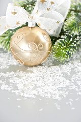 Fototapeta na wymiar golden christmas ball with ribbon