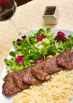 Tenderloin steaks in wine sauce with cadamon and kuskus groats