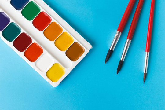 watercolor paints for children on a blue background