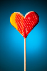 lollipop heart on blue background