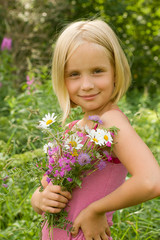 Fototapeta premium Beautiful Smiling Girl with Meadow Flowers Outdoor