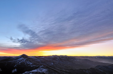 Mountain morning panorama with haze and burning sky