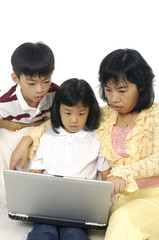 Parents and Daughter Using Laptop