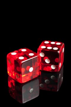 red dice on transparent black background