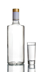 Bottle of vodka and wineglass isolated on white