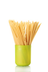 spaghetti in a bright green cup isolated on white