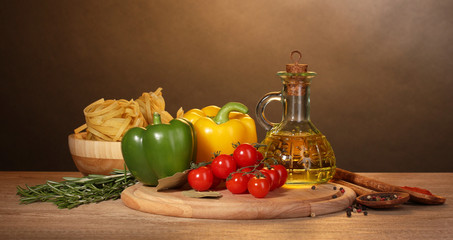 noodles in bowl, jar of oil, spices and vegetables
