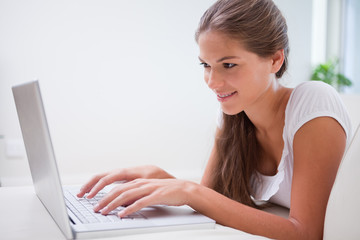 Side view of smiling woman on her laptop