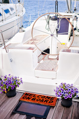 Welcome to the yacht, flowers and doormat at the entry