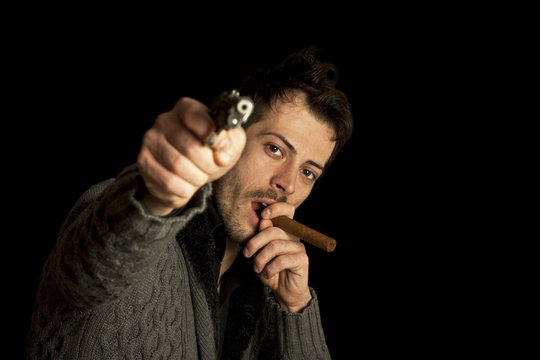 Mafia man smoking cigar with handgun
