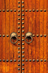 Fototapeta premium Detail of Brass Doorknobs on Exterior Door in Morocco