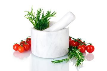 fresh green rosemary in mortar and tomatoes cherry isolated