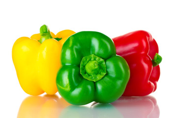 fresh green, red and yellow paprika isolated on white
