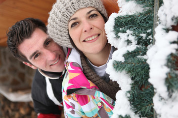 smiling couple and Christmas tree
