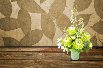 Colorful Artificial Flower Arrangement leaf and wood background