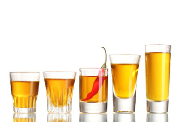 glasses of pepper vodka and red chili pepper isolated on white