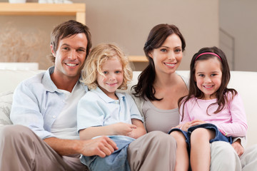 Cute family watching television together