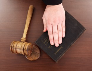 Hand on law book and gavel