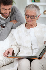 Elderly person looking at photos with son