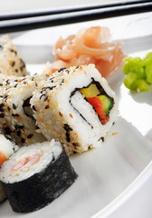 Sushi  rolls, wasabi and ginger on the white plate