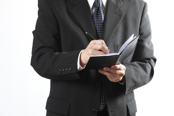 ノートを取るビジネスマン