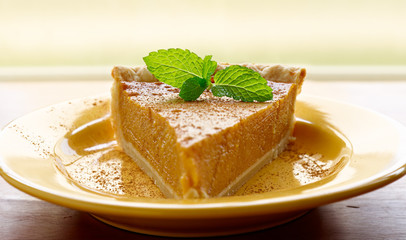 pumpkin pie with mint garnish and copyspace