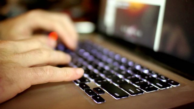 side view of a man working in his computer