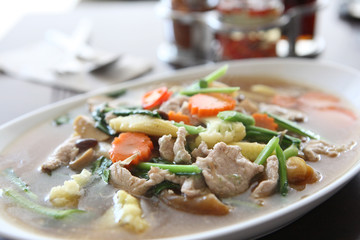 Thai food Wide Noodles in a Creamy Sauce with pork