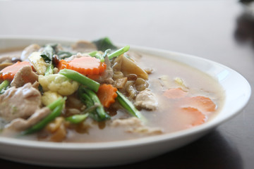 Thai food Wide Noodles in a Creamy Sauce with pork