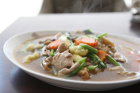 Thai food Wide Noodles in a Creamy Sauce with pork