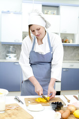 Attractive chief cook preparing food