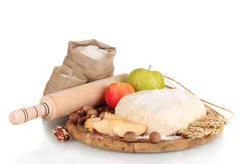 ingredients for homemade pie on wooden plate isolated on white