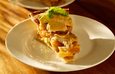 apple pie with mint garnish.
