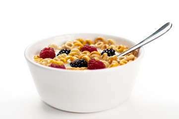 Cereals blackberries raspberries and milk in a bowl 01