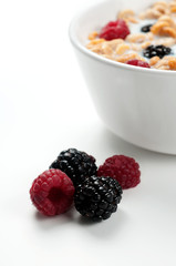 Cereals blackberries raspberries and milk in a bowl 03