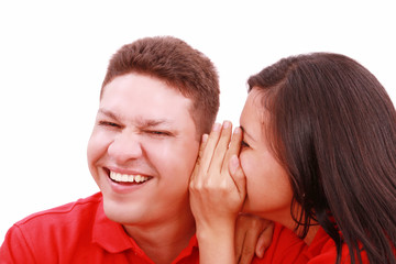 woman telling a man a secret - surprise and fun faces - over a w