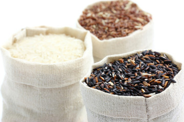 rice in small burlap sack isolated in white background