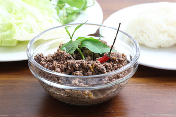 Thai food minced meat with vegetable and chilli on wood backgrou